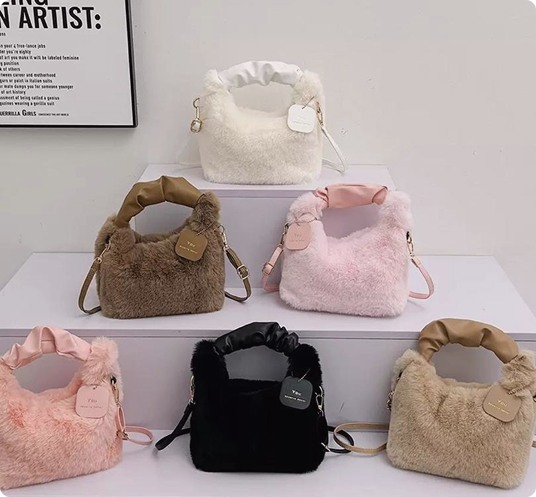 Fluffy handbags in six colours displayed on white steps